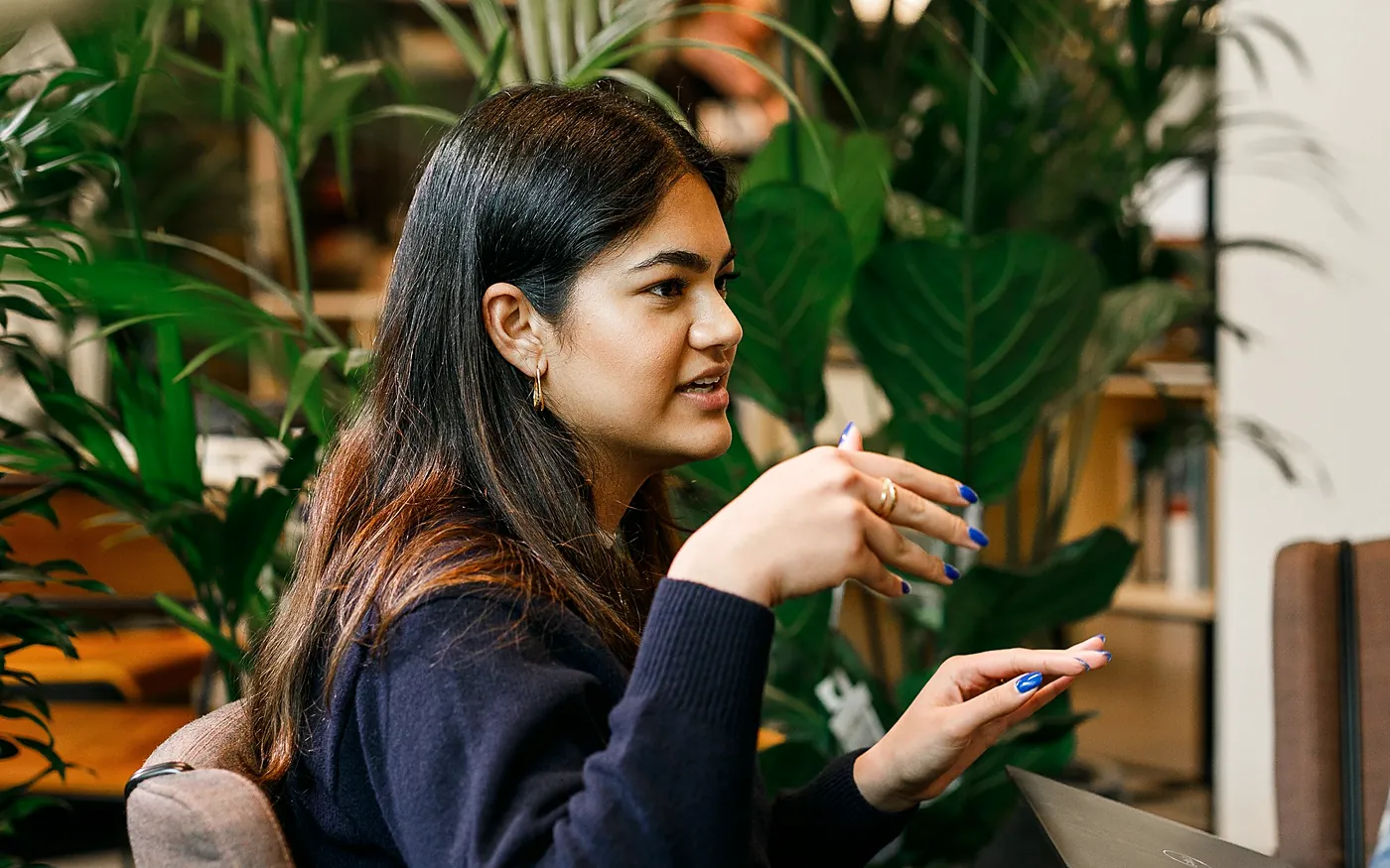A founder explaining her plans in a plant-filled office